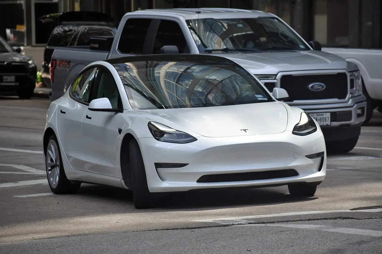 White Electric Vehicle on the Open Road