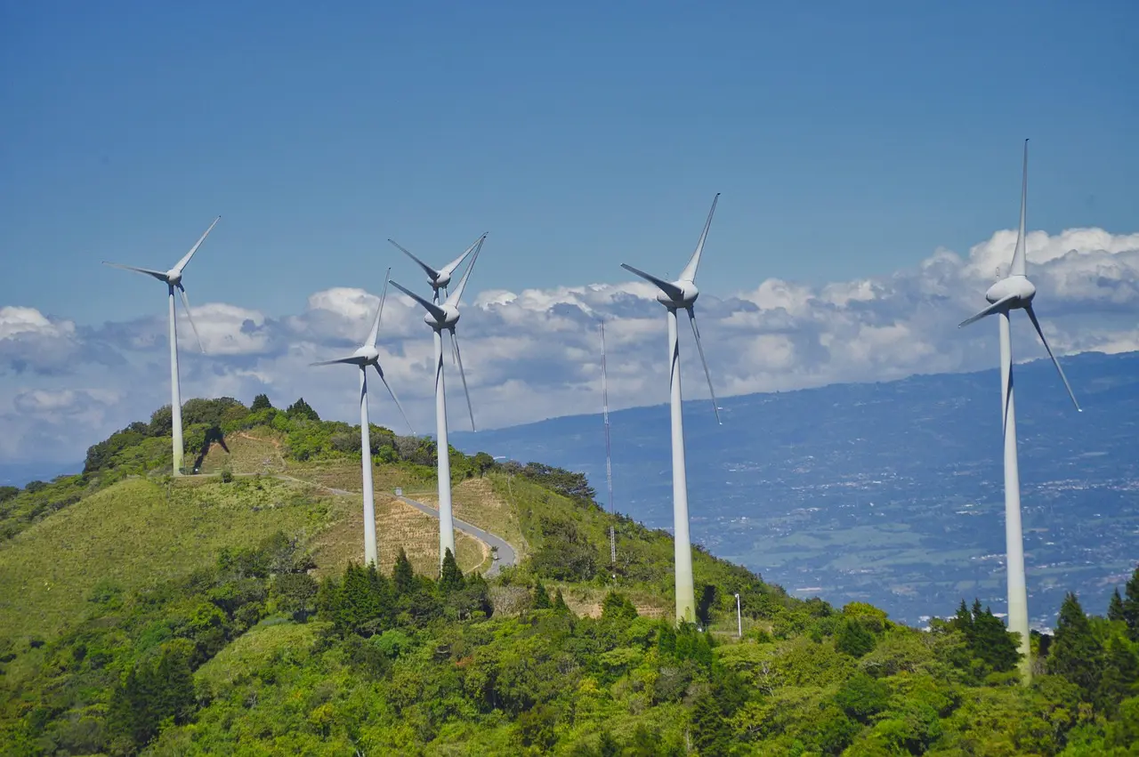 Wind Turbines standing on top of mountain peaks